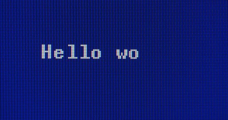typing hello world! on a blue computer screen. extreme closeup shot.