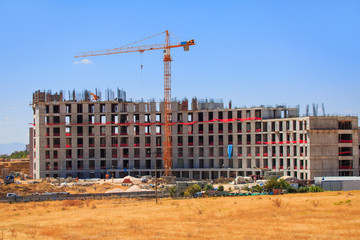 Crane on top of building and construction site