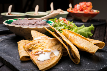 Wall Mural - Enchiladas with mexican dips in background