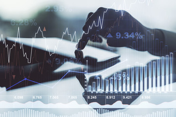 Multi exposure of abstract financial diagram and hand working with a digital tablet on background, banking and accounting concept