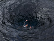 businessman falls into a whirlpool