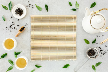 Wall Mural - Herbal tea with two white tea cups and teapot, with green tea leaves. Flat lay, top view. Tea concept