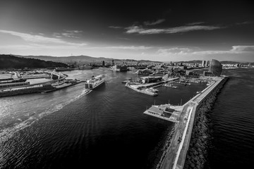 Wall Mural - Aerial view of Barcelona cityscape from helicopter. Harbor. in black and white. fine art