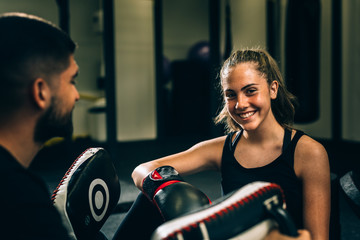 woman training kick box with his personal trainer