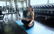 © FotoArtist - young woman working out in gym, young woman do yoga exercising in the gym