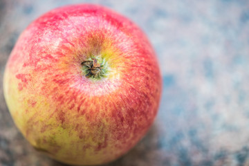 Wall Mural - Red organic apple on a granite background