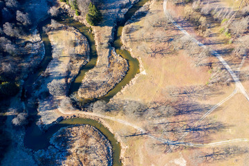 Wall Mural - Drone shot flying on spring river in forest