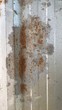 © Ekachai - Rust on the iron fence plate background on the wall.