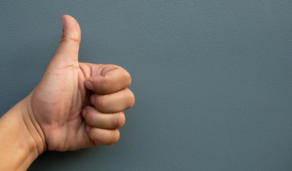 Hand making like symbol with fingers on a blue background.