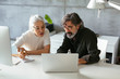 © Bonninstudio/Stocksy - Focused senior colleagues working on project together