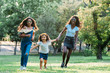 © David Prado/Stocksy - happy teenager girlfriends running having fun on park