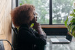© Viktor Solomin/Stocksy - Beautiful black african american business woman are sitting at the table with a laptop, working