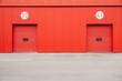 © Alina Hvostikova/Stocksy - Red Building Wall with Two Doors with Numbers