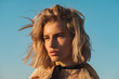 © Aleksandra Jankovic/Stocksy - Close Up Portrait Of Fashionable Woman With Messy Blond Hair Against The Blue Sky