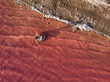 © David Prado/Stocksy - from above a Beautiful woman lying on inflatable mattress with white dress on pink sea