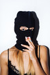 © Lucas Ottone/Stocksy - Masked woman smoking