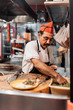 © Santi Nunez/Stocksy - Taquero making tacos