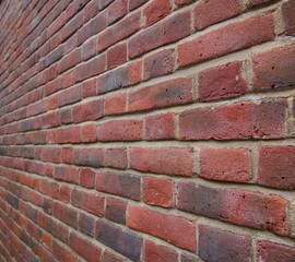 Neat background brick wall leading to vanishing point in the distance