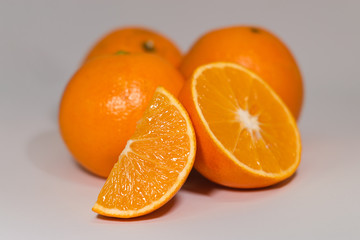 set of oranges, one cut in half and another in wedge