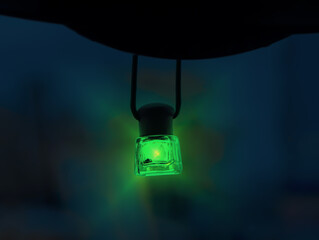 green lantern light bulb on dark background