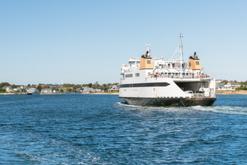 Huge car ferry sailing into a harbour on a clear autumn day