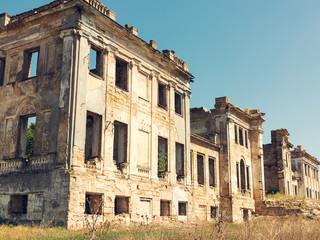 Wall Mural - Mystical Interior, ruins of facade of an abandoned ruined building of an ancient castle 18th century. Old ruined walls, corridor with garbage and mud. Ruins Ancient historic building destroyed by war