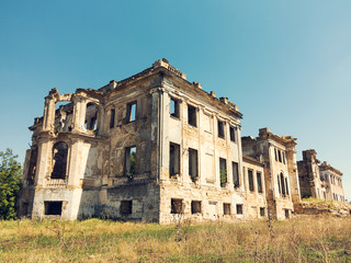 Wall Mural - Mystical Interior, ruins of facade of an abandoned ruined building of an ancient castle 18th century. Old ruined walls, corridor with garbage and mud. Ruins Ancient historic building destroyed by war