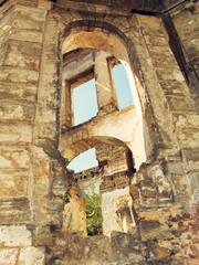 Wall Mural - Mystical Interior, ruins of facade of an abandoned ruined building of an ancient castle 18th century. Old ruined walls, corridor with garbage and mud. Ruins Ancient historic building destroyed by war