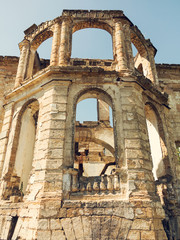 Wall Mural - Mystical Interior, ruins of facade of an abandoned ruined building of an ancient castle 18th century. Old ruined walls, corridor with garbage and mud. Ruins Ancient historic building destroyed by war