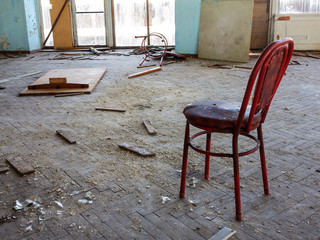 Wall Mural - Old furniture scattered around the room. Interior details inside the destroyed house of culture. The interior of the dying abandoned cinema room.