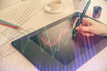 Double exposure of financial graph sketch hologram and woman holding and using a mobile device. Stock exchange concept.