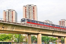 Singapore Subway Train On Elevated Tracks Through A Public Housing Estate