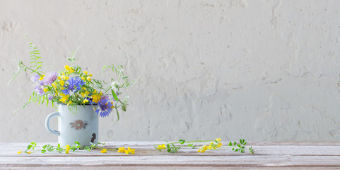 summer flowers in old cup on white background