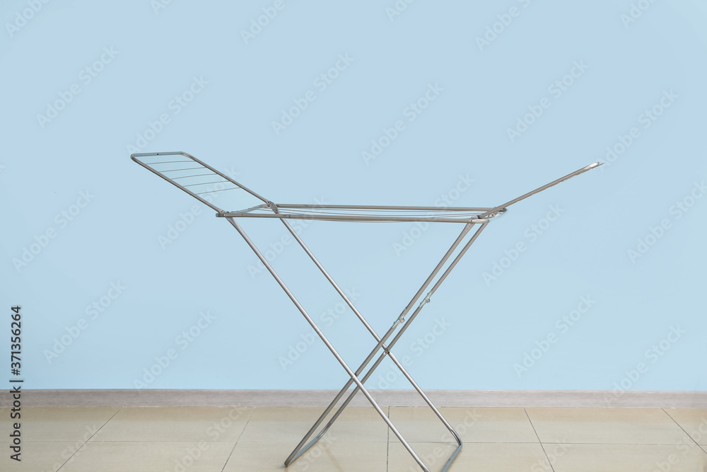 Empty clothes dryer near color wall