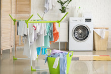 Clean Clothes Hanging On Dryer In Laundry Room
