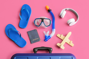 Sticker - Packed suitcase with beach accessories on color background. Travel concept