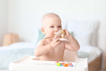 Wall Mural - Cute little baby with toy at home