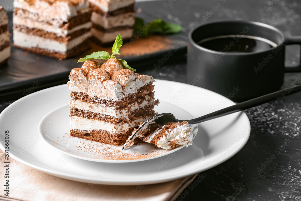 Plate with tasty tiramisu on table