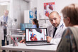 © DC Studio - Cardiologist talking with senior patient in hospital office about her heart diagnosis and recovery treatment wearing white coat and stethoscope. Elderly doctor writing on clipboard in clinic corridor.