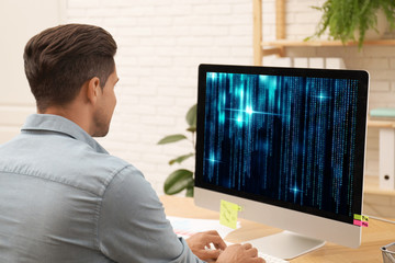 Professional programmer working with computer in office