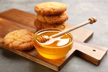 Wall Mural - Tasty honey and cookies on light grey table