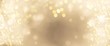 Festive abstract Christmas bokeh background - golden  bokeh lights beige - New Year, Anniversary, Wedding, banner
