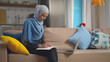 © TommyStockProject - Smart attractive muslim businesswoman using laptop for working online writing schedule down