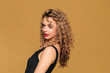 © Fototocam - beautiful young woman   with curl hair  posing  on beige  background - Image