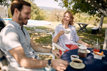 Wall Mural - Woman enjoying  outdoor  drinking coffee with her man.