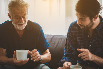 Portrait of happy smiling senior father at home, senior man in family concept