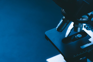 Laboratory equipment optical microscope, closeup of scientific microscope with metal lens, data analysis in the laboratory