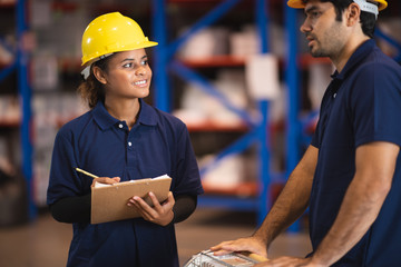 two warehouse logistic worker are working in warehouse industry storage