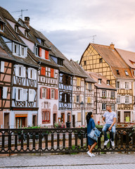 Wall Mural - couple on city trip Colmar, Alsace, France. Petite Venice, water canal and traditional half timbered houses. Colmar is a charming town in Alsace, France. Beautiful view of colorful romantic city