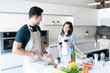 © AntonioDiaz - Couple Having Wine While Preparing Food